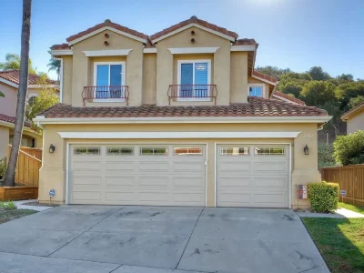 House in San Diego with a 3 car garage and a palm tree